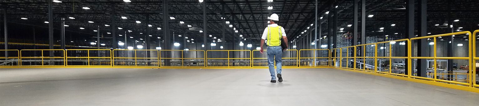 Man walking on a ResinDek Elevated Work Platfom Deck