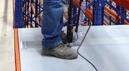 A worker using the Stand-Up Screw Gun